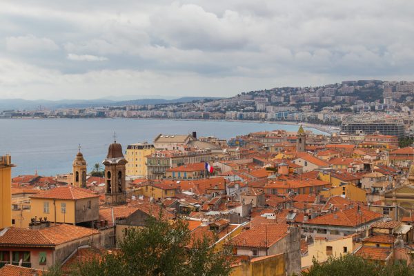 A high angle shot of architecture in Nice, France at daytime with the ocean in the background