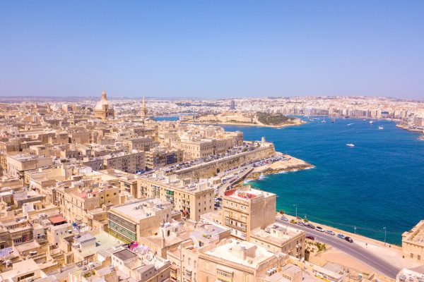 An aerial view of old town buildings near water in Valletta, Malta