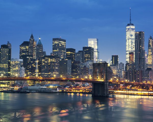 New York City Manhattan midtown at dusk with Brooklyn Bridge. USA.