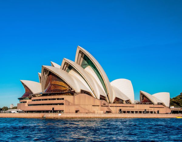 Sydney Opera House near the beautiful sea under the clear blue sky The Sydney Opera House near the beautiful sea under the clear blue sky