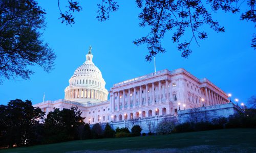Capitol Hill Building at dusk with light and blue sky, Washington DC.