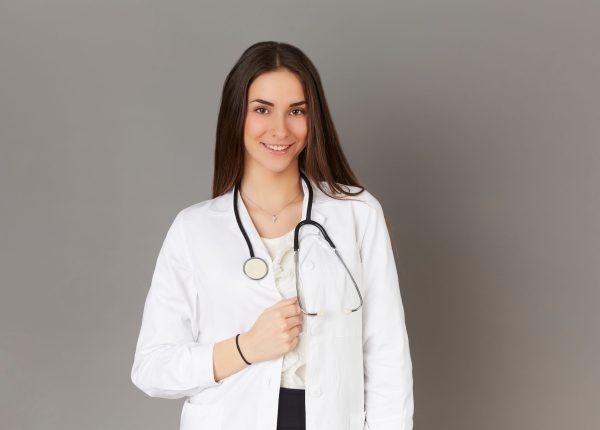 young female doctor - gray background