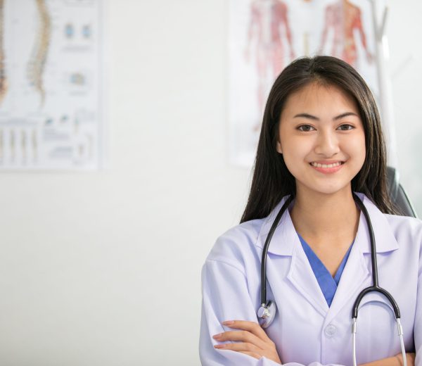 Young woman doctor smiling and working at office