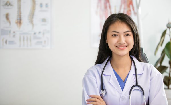 Young woman doctor smiling and working at office