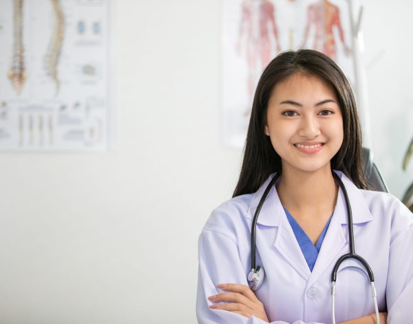 Young woman doctor smiling and working at office