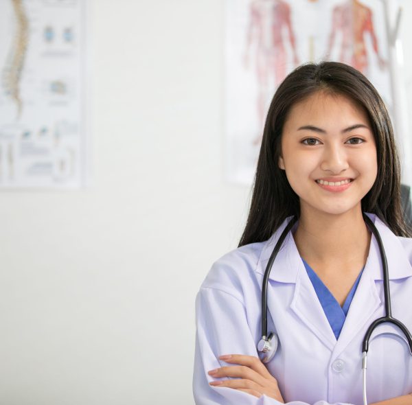 Young woman doctor smiling and working at office